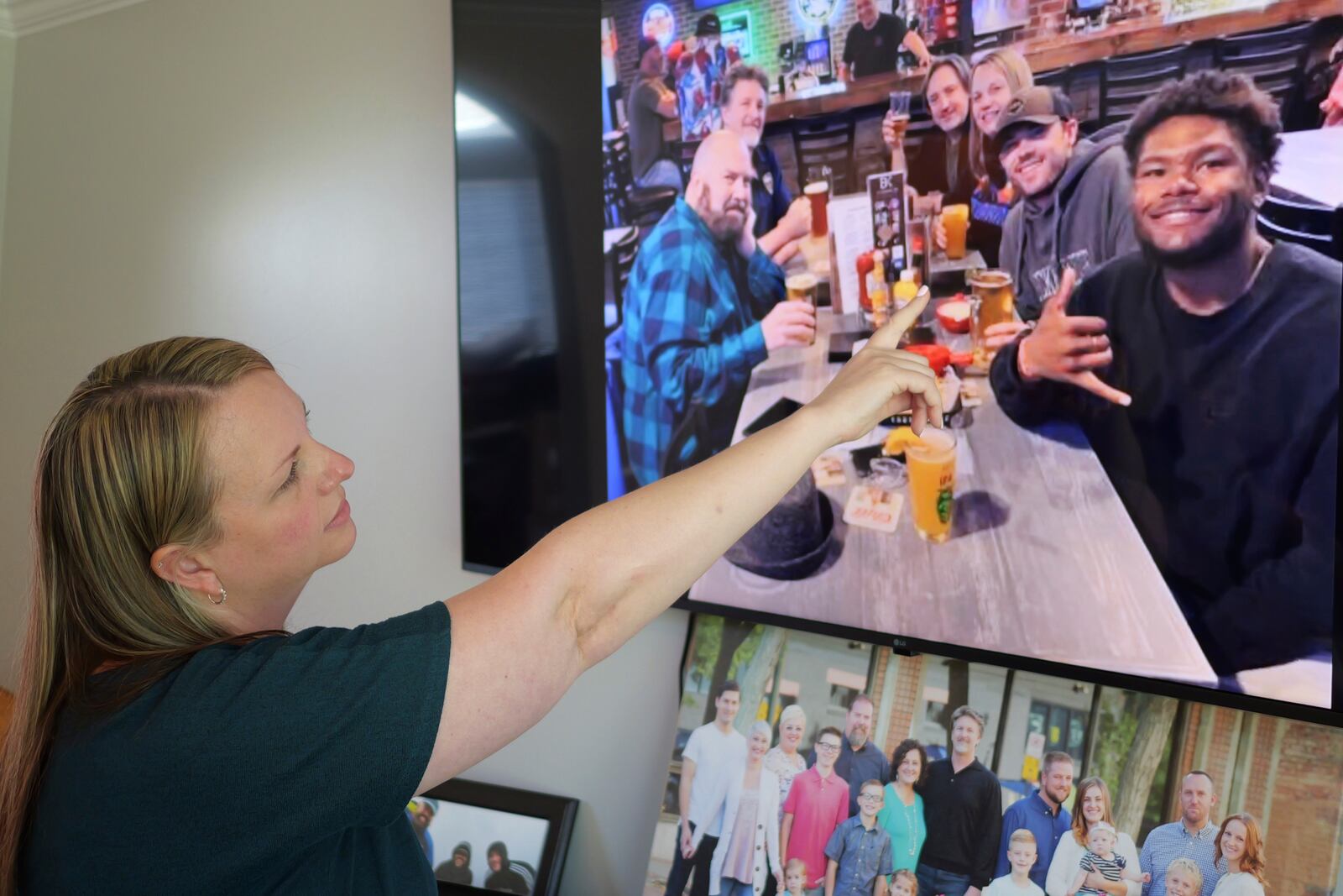 FILE - Rebecca Higbee the mother of Tyler Thompson, points to her son and his friend Marcel during his 21st birthday with his family on May 30, 2024, in West Jordan, Utah. (AP Photo/Rick Bowmer, File)