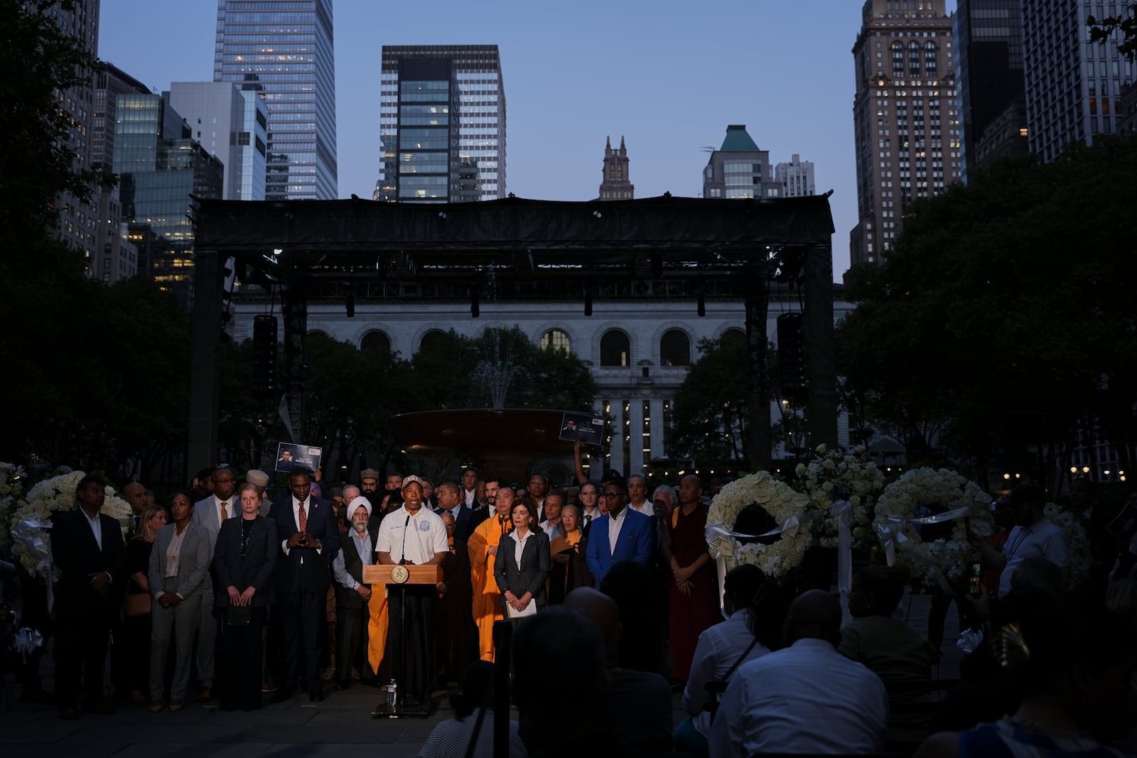 New York Mayor Eric Adams speaks during a vigil for the people killed by a gunman at a Manhattan office building a day prior, Tuesday, July 29, 2025, at Bryant Park in New York. (AP Photo/Angelina Katsanis)