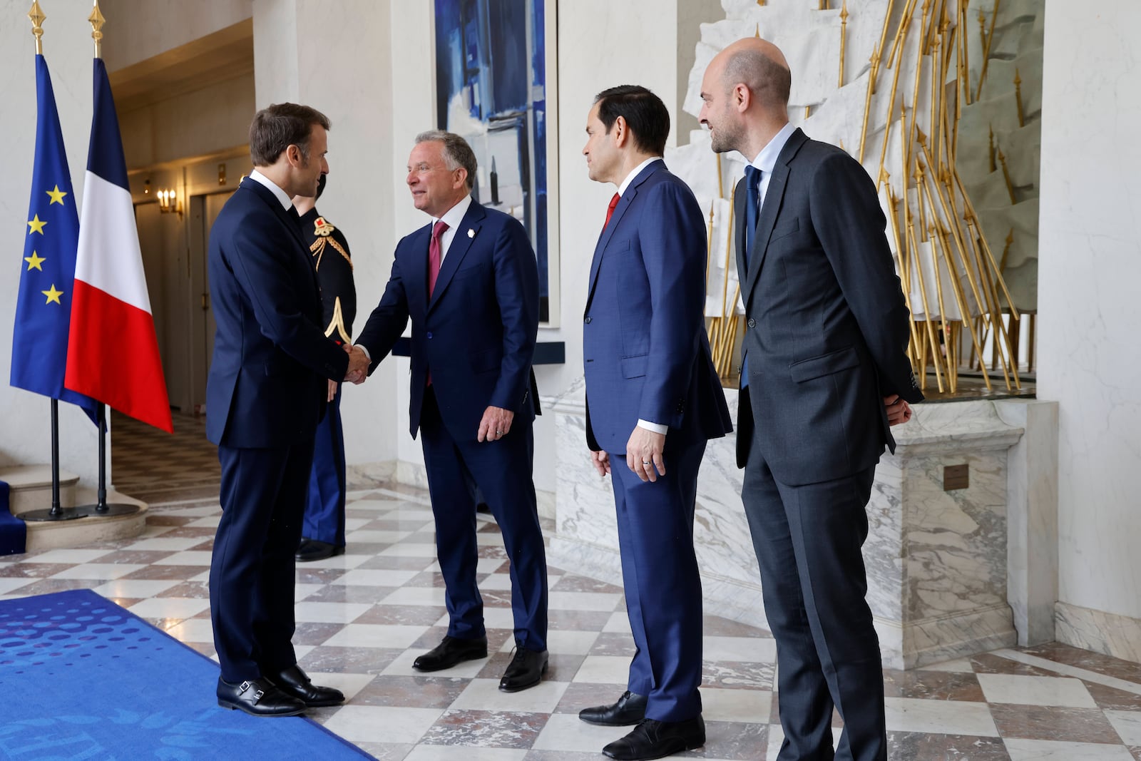 French President Emmanuel Macron, left, welcomes US Special Envoy Steve Witkoff, center, US Secretary of State Marco Rubio, 2nd right, and France's Minister for Foreign Affairs Jean-Noel Barrot for a meeting at the Elysee Palace in Paris, Thursday April 17, 2025. (Ludovic Marin, Pool Photo via AP)