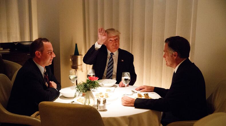 President-elect Donald Trump, center, eats dinner with Mitt Romney, right, and Trump Chief of Staff Reince Priebus at Jean-Georges restaurant, Tuesday, Nov. 29, 2016, in New York. (AP Photo/Evan Vucci)