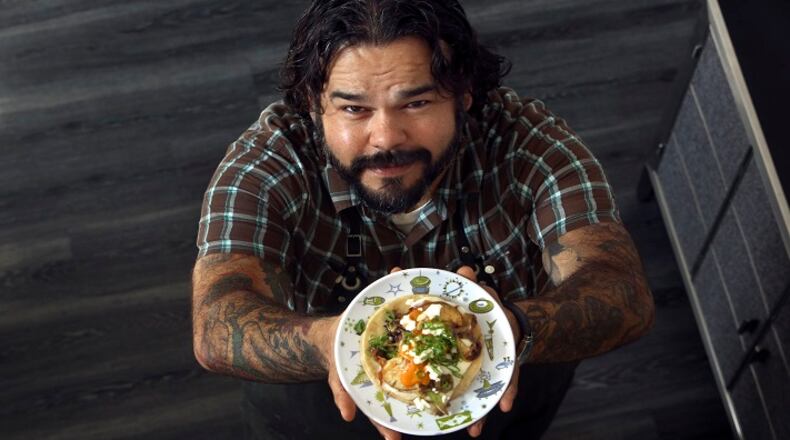 Wes Avila of Guerrilla Tacos holds up a sweet potato breakfast taco that he made at his home in Glendale, Calif., on February 16, 2015. (Mel Melcon/Los Angeles Times/TNS)