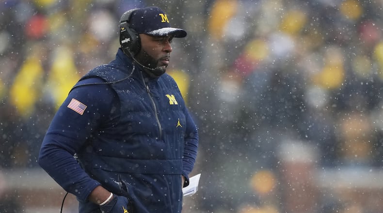 Michigan head coach Sherrone Moore watches from the sideline during the second half of an NCAA college football game against Ohio State, Saturday, Nov. 29, 2025, in Ann Arbor, Mich. (AP Photo/Ryan Sun)