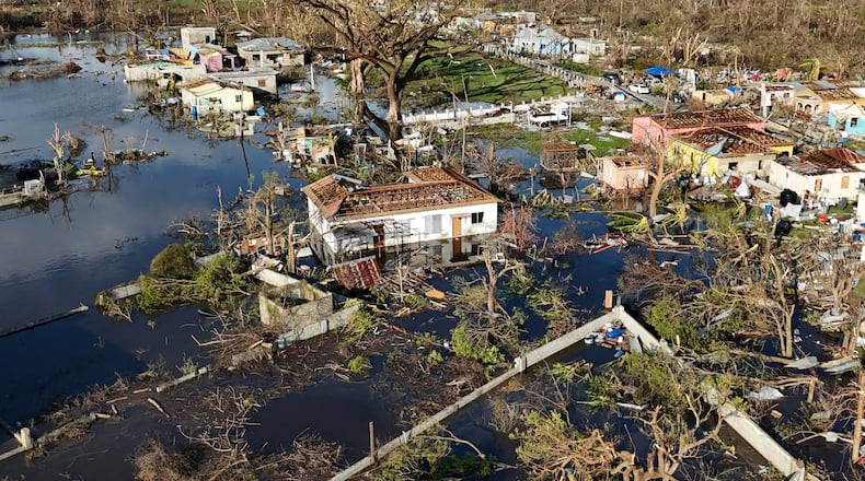 FILE - Debris surrounds damaged homes along the Black River, Jamaica, Thursday, Oct. 30, 2025, in the aftermath of Hurricane Melissa. (AP Photo/Matias Delacroix, File)
