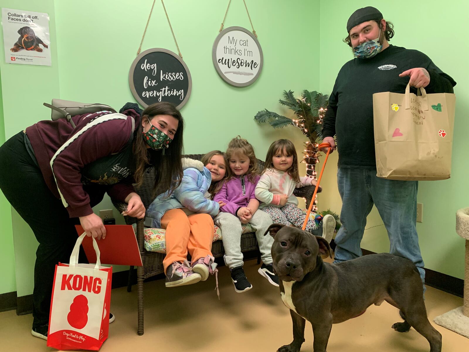 A family poses with the dog they adopted from the Greene County Animal Care and Control shelter. The shelter entered a contest to see what shelter could adopt out the most pets during the holiday season. CONTRIBUTED