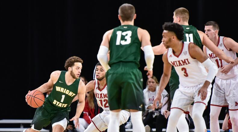 Wright State’s Justin Mitchell dribbles the ball during their game Tuesday, Nov. 14 at Millett Hall on the Miami University Campus in Oxford. The Redhawks defeated the Raiders 73-67 in overtime. NICK GRAHAM/STAFF