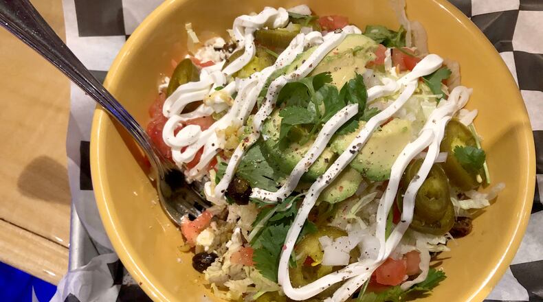 Latin Arepas is located with in Bar Granada on Monument Avenue on Dayton. A rice bowl is pictured.