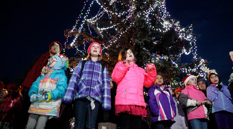 A choir of students from Wright-Patterson Air Force Base sing at the base’s Christmas tree lighting in this 2014 photo. LISA POWELL/STAFF