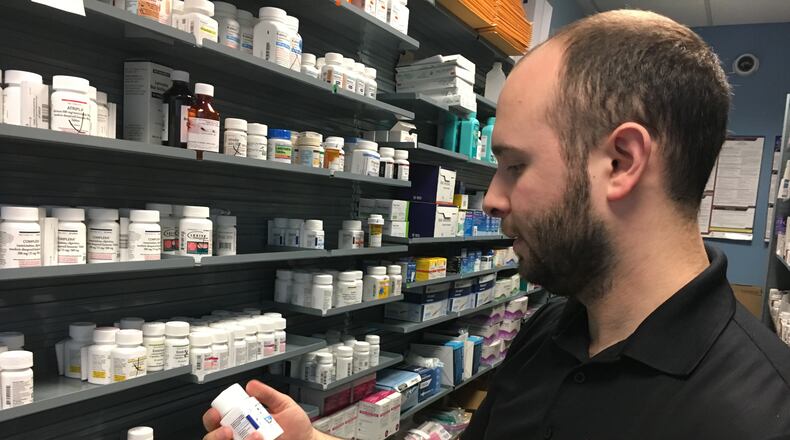 Pharmacist Phil Pauvlinch works at the Equitas Health Pharmacy in Dayton, formerly AIDS Resource Center Ohio. Hepatitis C and HIV patients who get pharmacy benefits through Medicare Part D are being hit hard by rising out-of-pocket costs. KATIE WEDELL/STAFF