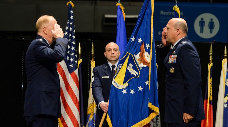 U.S. Air Force Col. Patrick Miller,  right, assumes command of the 88th Air Base Wing from Lt. Gen. Robert McMurry, Air Force Life Cycle Management Center commander, left, during a change of command ceremony Friday.
