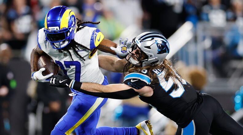 Los Angeles Rams wide receiver Davante Adams (17) is tackled by Carolina Panthers linebacker Christian Rozeboom during the second half of an NFL wild-card playoff football game, Saturday, Jan. 10, 2026, in Charlotte, N.C. (AP Photo/Rusty Jones)