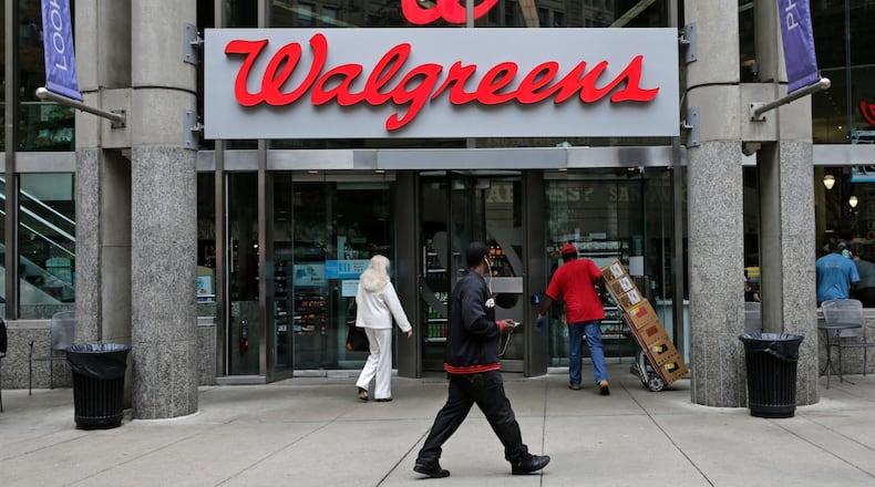 FILE - This June 4, 2014, file photo, shows a Walgreens retail store in Boston. Walgreens and Rite Aid will sell 865 stores to rival retailer Fred’s for $950 million, possibly removing the final roadblock preventing the tie up between the nation’s largest and third-largest drugstore chains, in news announced Tuesday, Dec. 20, 2016. (AP Photo/Charles Krupa, File)