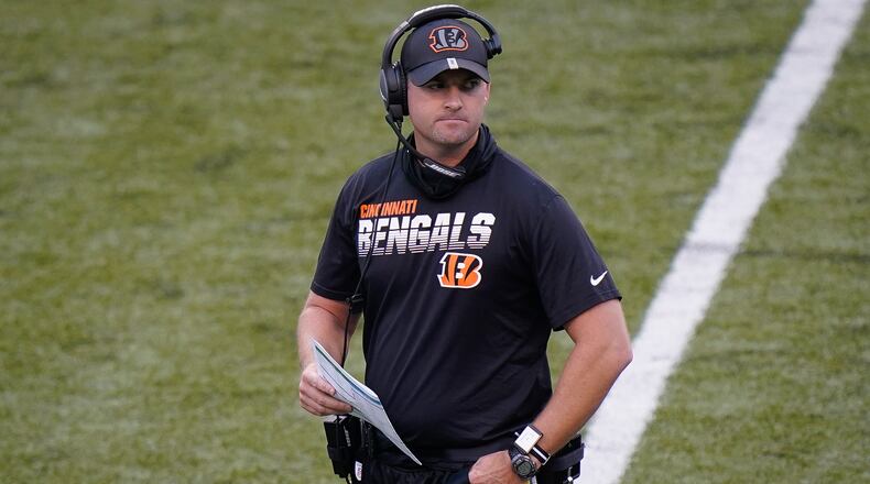 Cincinnati Bengals head coach Zac Taylor walks on the field during an NFL football team scrimmage in Cincinnati, Sunday, Aug. 30, 2020. (AP Photo/Bryan Woolston)