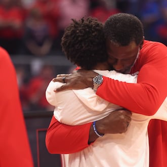 Dayton's Anthony Grant hugs Javon Bennett during a Senior Night ceremony before a game against Virginia Commonwealth on Friday, March 6, 2026, at UD Arena. David Jablonski/Staff