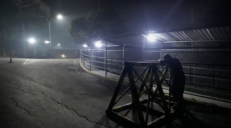 A relative of a political prisoner waits outside the Rodeo I prison in Guatire, Venezuela, Thursday, Jan. 8, 2026, after National Assembly President Jorge Rodriguez said the government would release Venezuelan and foreign prisoners. (AP Photo/Matias Delacroix)