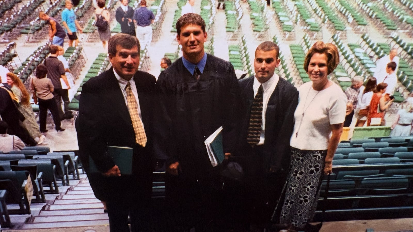 Flanked by their parents, Jim and Becky Brown, Matt Brown (second from right) with his brother Anthony on their graduation day at Wright State in 1999. CONTRIBUTED PHOTO
