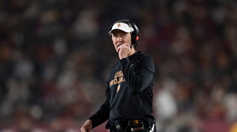 Southern California head coach Lincoln Riley walks on the field during the first half of an NCAA college football game against UCLA, Saturday, Nov. 29, 2025, in Los Angeles. (AP Photo/Kyusung Gong)