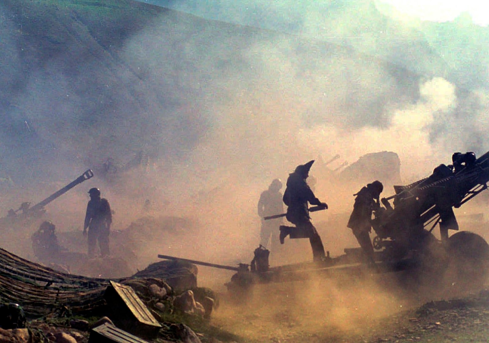 FILE - Indian artillery guns are engulfed in smoke in Dras, some 155 kilometers (96 miles) north of Srinagar, India, as Indian troops fight Pakistani intruders in the disputed Kashmir on July 10, 1999. (AP Photo/Aijaz Rahi, File)