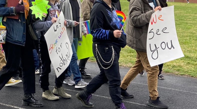 Students with signs march outside of the Stivers School for the Arts Friday morning in support of the school's LGBTQ+ students, who staged a walkout on Friday. Eileen McClory / Staff
