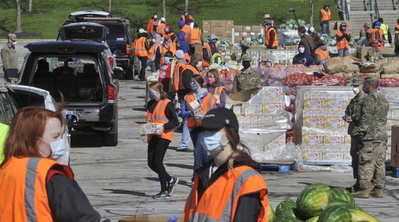 Pictured is The Foodbank’s mass distribution at the Nutter Center. MARSHALL GORBY/STAFF