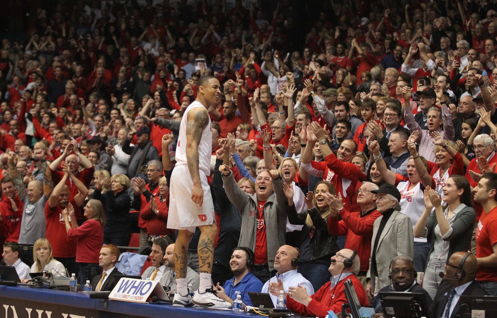 Dayton’s Kyle Davis jumps on the scorer’s table after a victory against Virginia Commonwealth on Wednesday, March 1, 2017, at UD Arena.