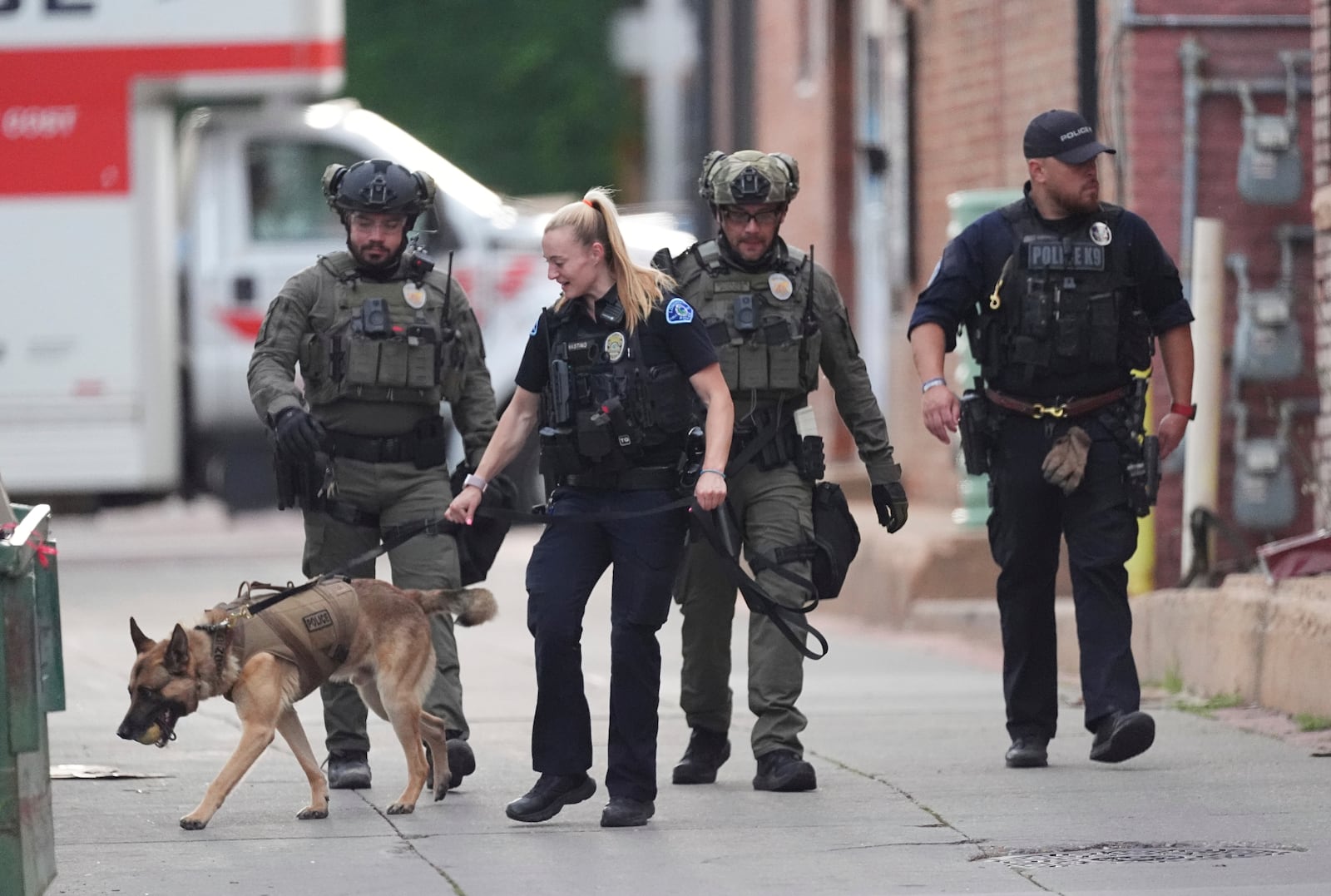 Law enforcement officials investigate after an attack on the Pearl Street Mall Sunday, June 1, 2025, in Boulder, Colo. (AP Photo/David Zalubowski)