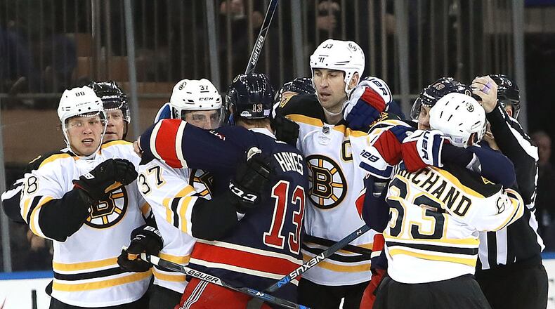 NEW YORK, NY - OCTOBER 26: Referees break up a scuffle between the Boston Bruins and the New York Rangers during the second period at Madison Square Garden on October 26, 2016 in New York City. (Photo by Michael Reaves/Getty Images)