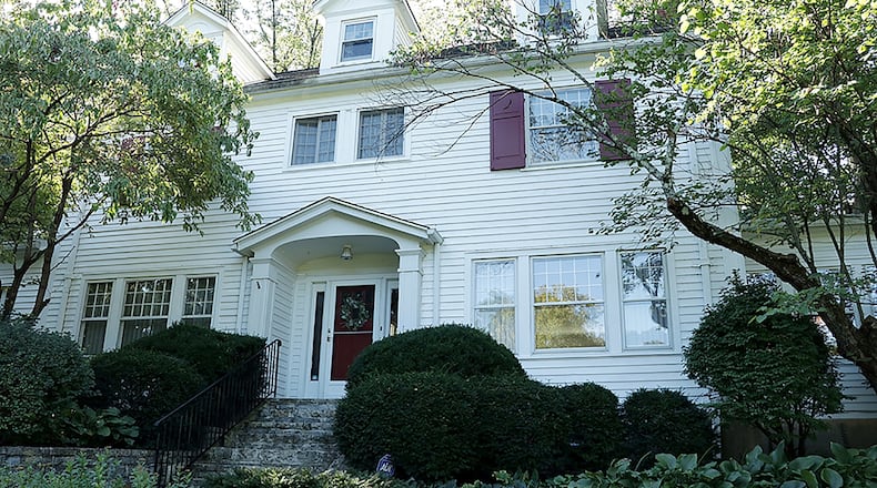 The 5-bedroom frame home has about 4,020 sq. ft. of living space plus a shady brick terrace that overlooks the near acre property. A paved driveway curved among the trees to the side-entry, 2-car, attached garage. CONTRIBUTED PHOTO BY KATHY TYLER