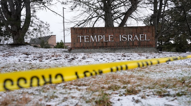 Police tape hangs outside the Temple Israel synagogue Friday, March 13, 2026, in West Bloomfield Township, Mich. (AP Photo/Paul Sancya)