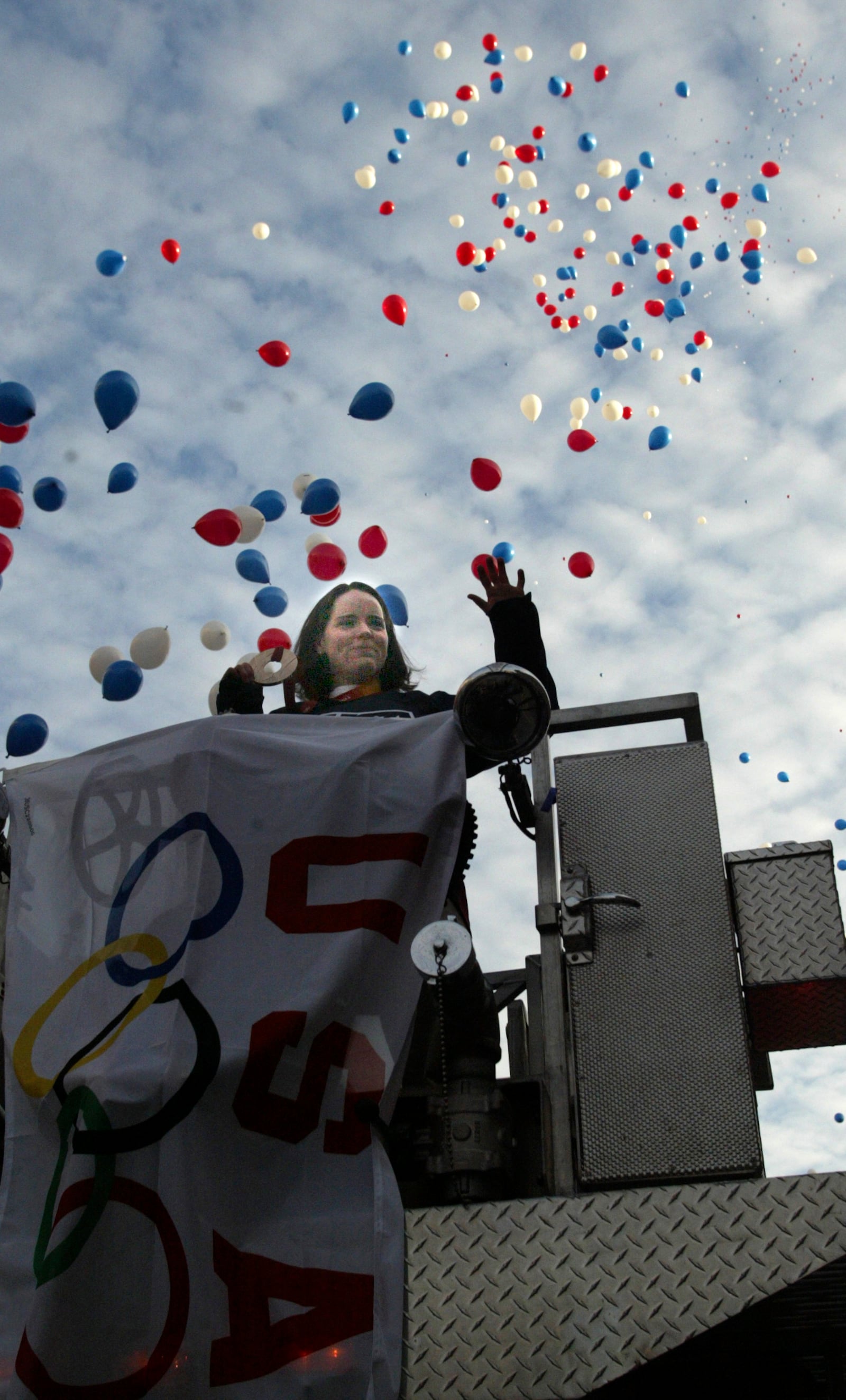 Olympic women's hockey team member Kristin King comes in with her Bronze medal riding an aerial ladder truck during a celebration on Feb. 28, 2006 in Piqua. BILL GARLOW / STAFF