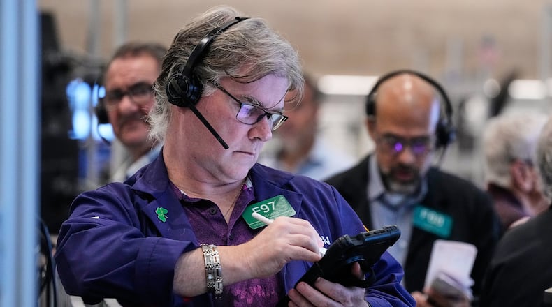 Options trader Brian Garvey, left, works on the floor of the New York Stock Exchange, Monday, Oct. 20, 2025. (AP Photo/Richard Drew)
