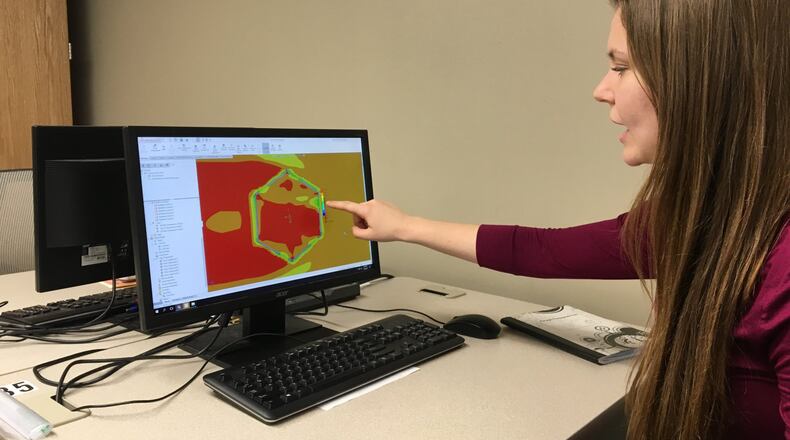 Grace Littlefield, a Cedarville engineering student, describes tests that she ran on a refugee shelter design to gauge its ability to withstand heat and cold. Littlefield is one of five seniors designing a shelter that could be used in refugee camps.