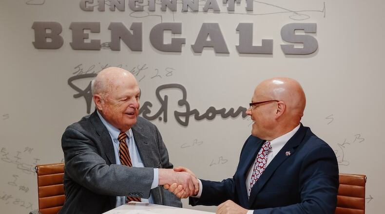 At a joint press conference Wednesday morning at the Bengals Paycor Stadium, Bengals and Miami University officials unveiled a formal agreement creating a number of advertising, internship and cross-marketing programs between the two. Pictured are Bengals Owner Mike Brown (left) and Miami President Gregory Crawford after signing the first-ever partnership. (Provided by Miami University)