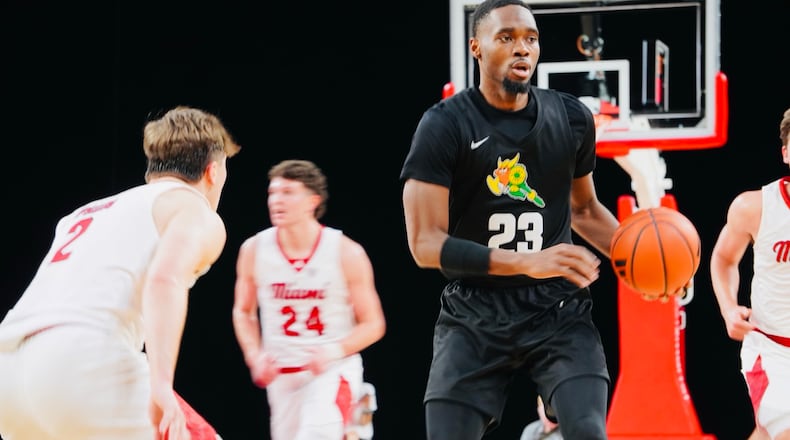 Wright State's Jack Doumbia (23) is guarded by Miami's Evan Ipsaro on Saturday at Millett Hall. Chris Vogt/CONTRIBUTED