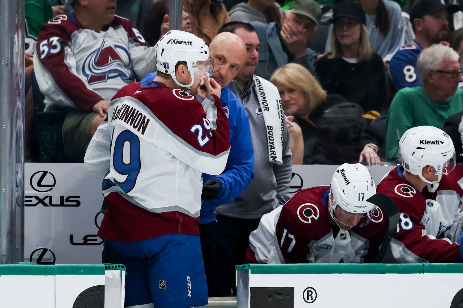 Colorado Avalanche center Nathan MacKinnon (29) is attended to by medical staff after he was high-sticked during a first-round NHL hockey playoff game against the Dallas Stars in Dallas, Saturday, April 19, 2025. (AP Photo/Gareth Patterson)