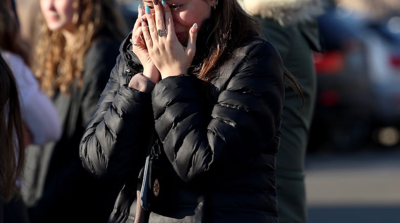 A woman reacts near the Lynch Arena in Pawtucket, R.I., after a shooting at the ice rink, Monday, Feb. 16, 2026. (AP Photo/Mark Stockwell)