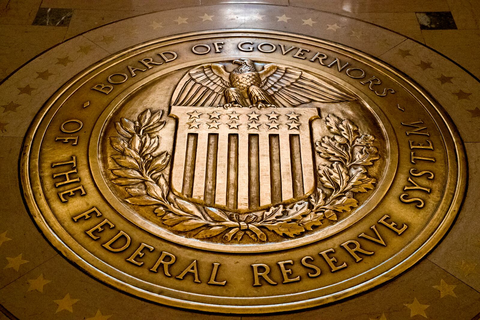 FILE- In this Feb. 5, 2018, file photo, the seal of the Board of Governors of the United States Federal Reserve System is displayed in the ground at the Marriner S. Eccles Federal Reserve Board Building in Washington. AP Photo/Andrew Harnik, File)