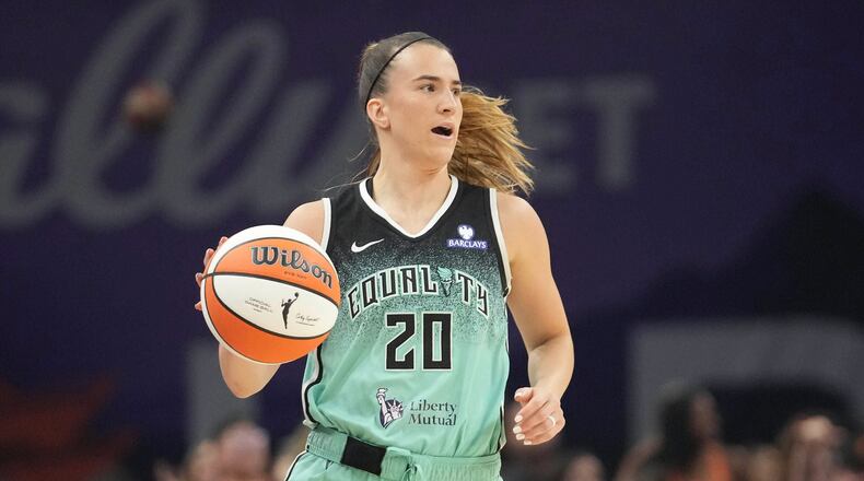 FILE - New York Liberty guard Sabrina Ionescu controls the ball against the Phoenix Mercury during the second half of Game 1 during the first round of the WNBA basketball playoffs Sept. 14, 2025, in Phoenix. (AP Photo/Darryl Webb, File)