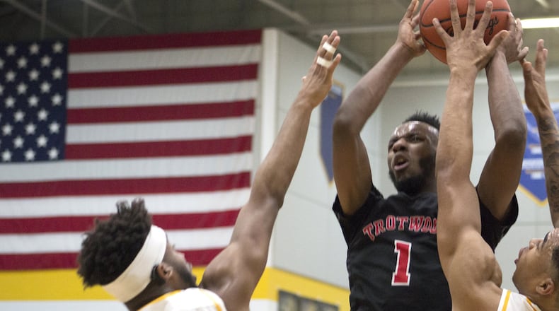 Trotwood-Madison’s Amari Davis shoots over Springfield’s Larry Stephens (1) and RaHeim Moss during the Rams’ 94-87 victory Friday night. Davis scored 43 points. Jeff Gilbert/CONTRIBUTED