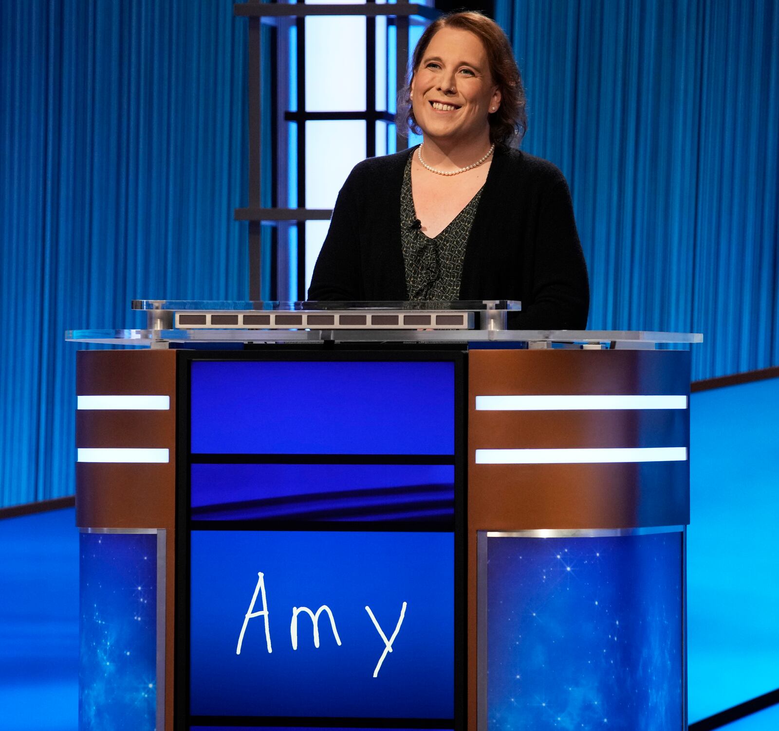 This image provided by Jeopardy Productions, Inc. shows game show champion Amy Schneider on the set of "Jeopardy!" Schneider is the first trans person to qualify for the show's Tournament of Champions. (Jeopardy Productions, Inc. via AP)