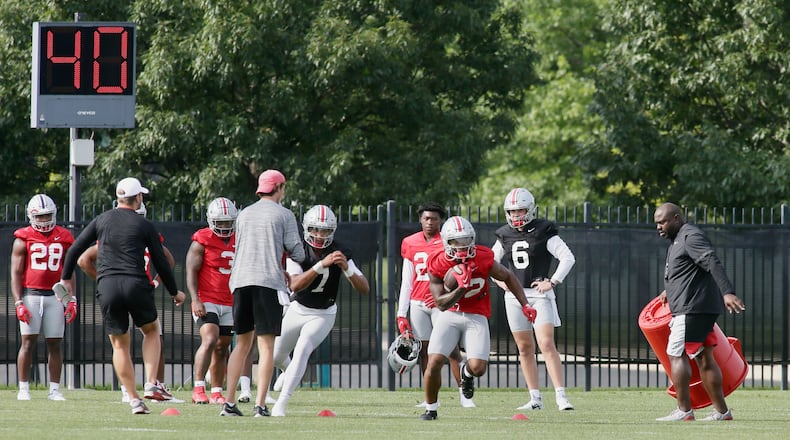 TreVeyon Henderson carries the ball after a handoff from C.J. Stroud at the first Ohio State practice of the season on Thursday, Aug. 4, 2022, at the Woody Hayes Athletic Center in Columbus. David Jablonski/Staff