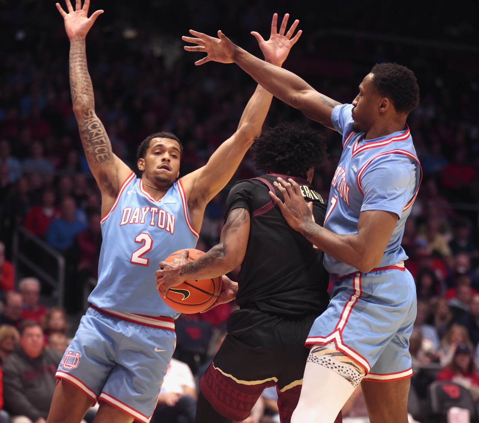 Dayton's De'Shayne Montgomery and Keonte Jones defend against Florida State on Tuesday, Dec. 16, 2025, at UD Arena. David Jablonski/Staff