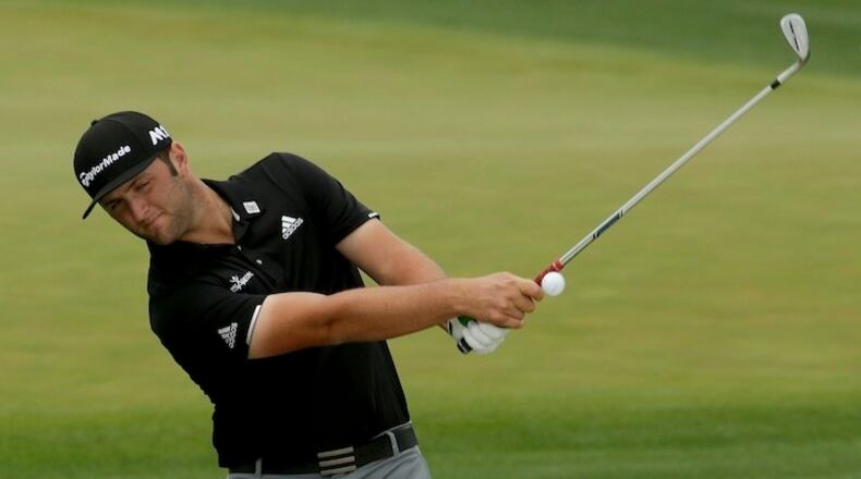 Jon Rahm, of Spain, hits out of the bunker on the driving range during practice for the Masters golf tournament Monday, April 3, 2017, in Augusta, Ga. (AP Photo/Charlie Riedel)