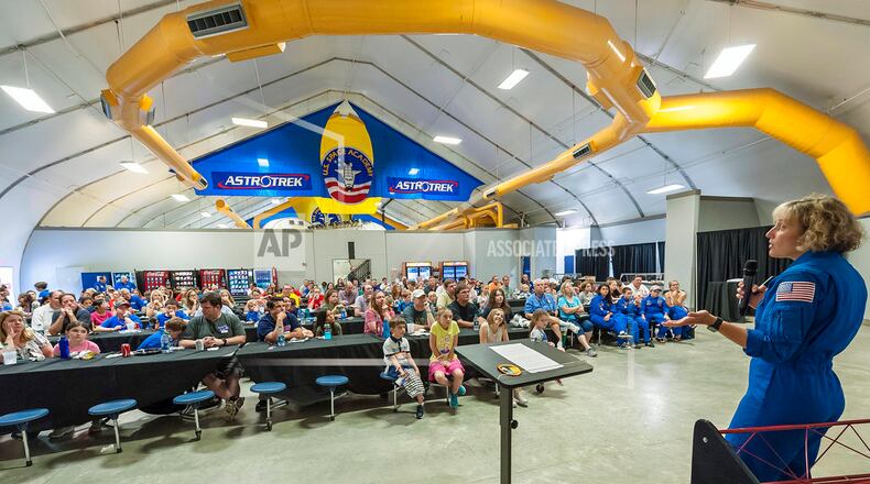 In this July 13, 2018 photo, NASA astronaut Dottie Metcalf discusses space travel and her experiences in space at the U.S. Space & Rocket Center in Huntsville, Ala. Huntsville's tourism industry is rooted in the U.S. space program and its critical, ongoing research into getting astronauts back to the moon and on to Mars. (AP Photo/Vasha Hunt)