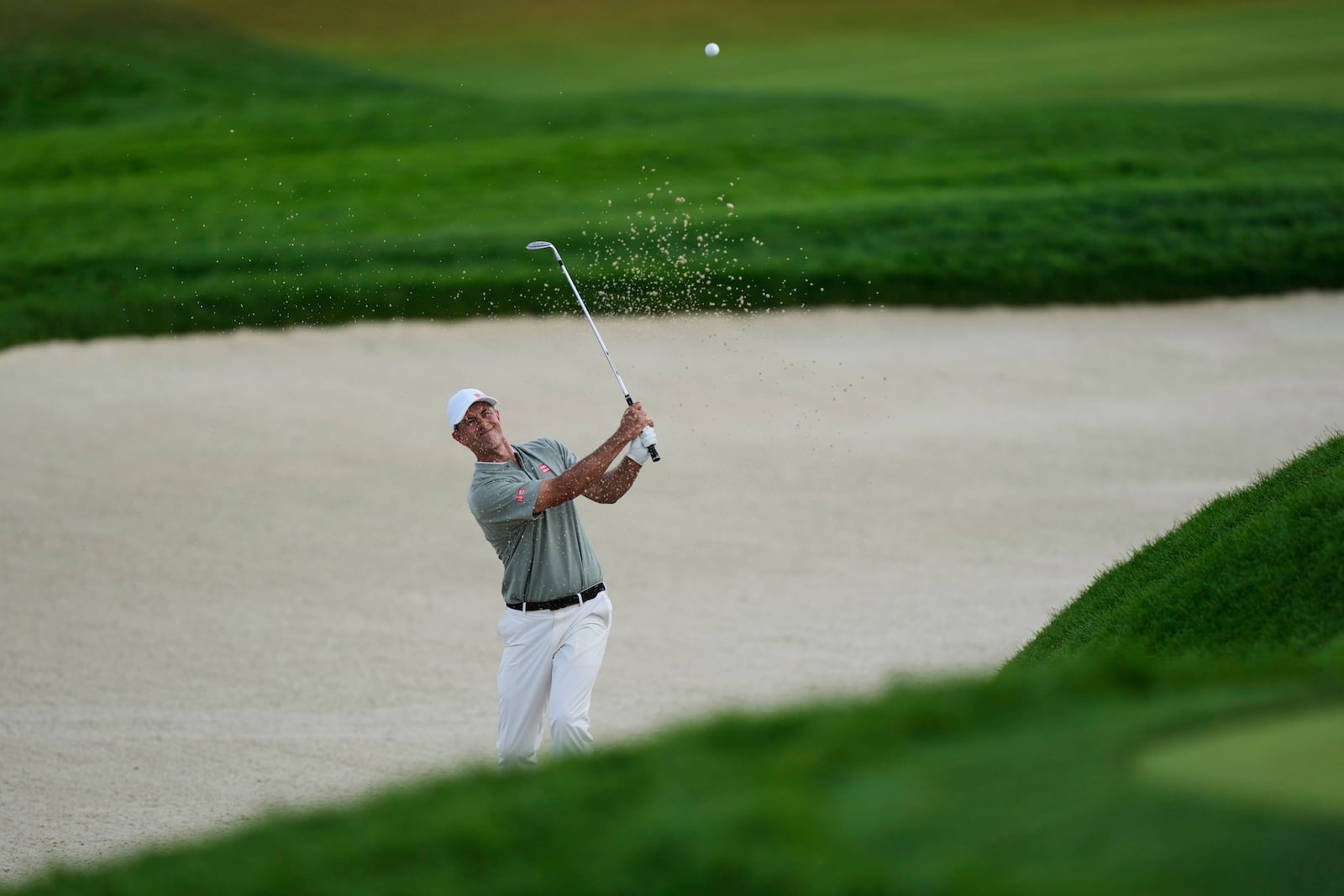 Adam Scott, of Australia, hits from a bunker on the 15th hole during the third round of the U.S. Open golf tournament at Oakmont Country Club Saturday, June 14, 2025, in Oakmont, Pa. (AP Photo/Charlie Riedel)
