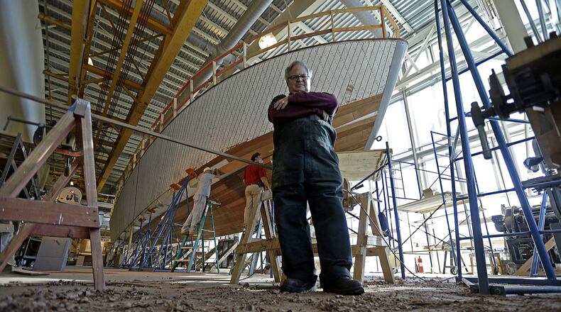 FILE - In this Dec. 18, 2013 file photo, Tom Czekanski, director of collections and exhibits at the National World War II Museum, stands in froth of one of the surviving World War II-era PT boats as it undergoes restoration in New Orleans.  The PT-305, a U.S. Navy patrol torpedo boat that sank three vessels and saw action in Europe, is back in New Orleans where it was built and tested - what historians describe as the nation's only fully restored ship of that type that saw direct combat in World War II. (AP Photo/Gerald Herbert, File)
