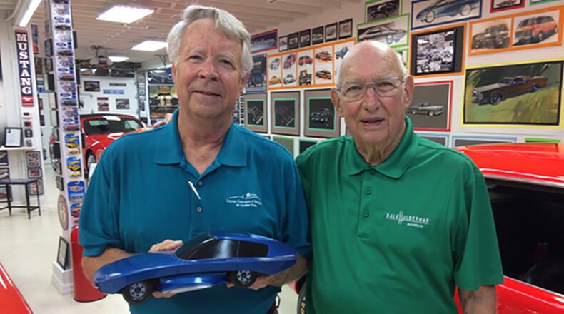 Dayton Concours d Elegance Grand Marshall Gale Halderman, right, shows Fisher Body Craftsman’s Guild host George Herzog around his Halderman Barn Museum in Tipp City. Herzog is holding one of his models. Photo contributed by Karen Koenig