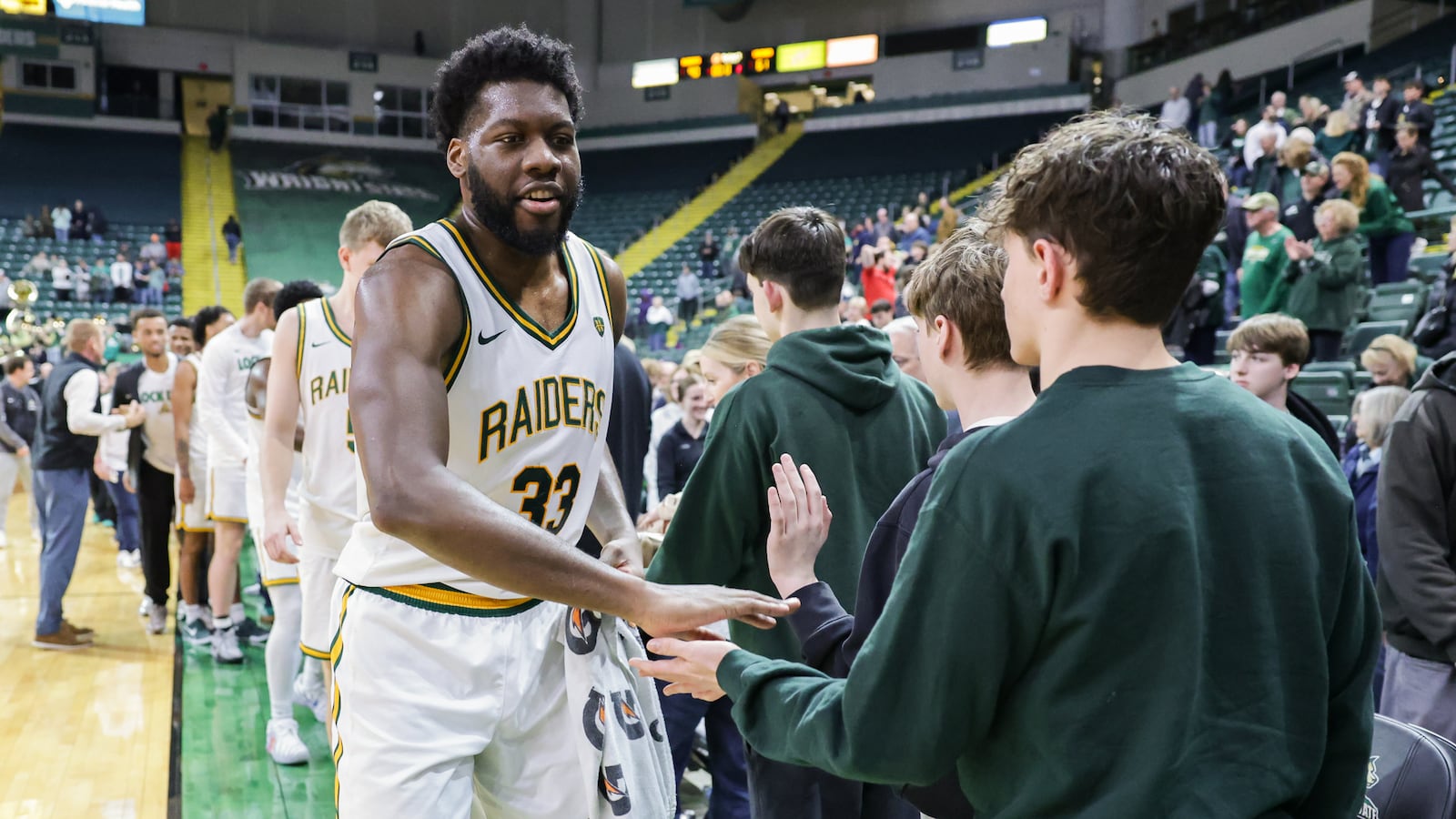 Wright State fifth-year senior forward Michael Imariagbe shakes hands with fans following the Raiders' 90-61 win over Cleveland State in a Horizon League Championship first-round game on Wednesday, March 4 at Ervin J. Nutter Center in Fairborn. Imariagbe scored 16 points and had five rebounds. BRYANT BILLING / STAFF