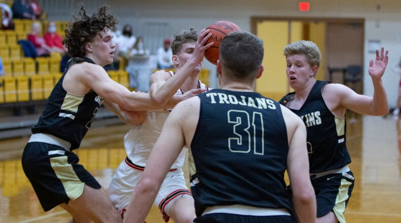 Bokins starters Carter Pleiman (left), Jacob Pleiman (31) and Zane Paul surround Cedarville's Trent Koning in the regional final last Friday. The Trojans will face Richmond Heights at 11 a.m. Friday in the Division IV state semifinal at UD Arena. Jeff Gilbert/CONTRIBUTED