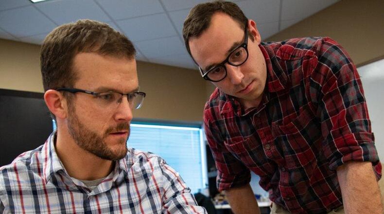 Joe Althaus (left), Wright Brothers Institute Rapid Innovation program manager, determines the power consumption of a piece of equipment as Isaac Weintraub, an electronics engineer with Air Force Research Laboratory’s Aerospace Systems Directorate, observes during a rapid innovation session at AFRL’s Maker Hub. Rapid prototyping such as this supports the Secretary of the Air Force Heather Wilson’s focus on getting battlefield solutions to warfighters faster. (U.S. Air Force photo/John Harrington)