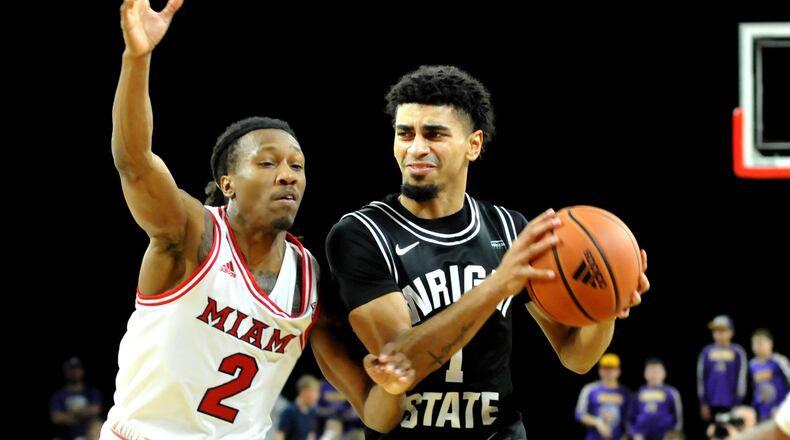 Wright State's Trey Calvin, 1, drives past Miami's Mekhi Lairy, 2, during the first half of a non-conference game at Millett Hall on Thursday, Dec. 22. DAVID A. MOODIE/CONTRIBUTING PHOTOGRAPHER